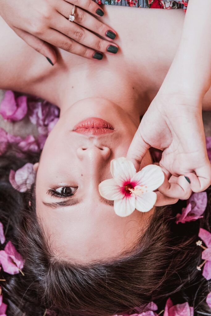 Photo of Woman Holding Pink Flower